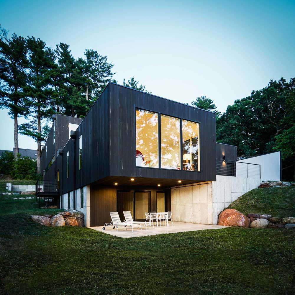 Stepped House on the Hillside Between City and Forest