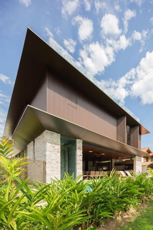 Two Storey Minimalist House Design With Wooden Shutters On The Facade