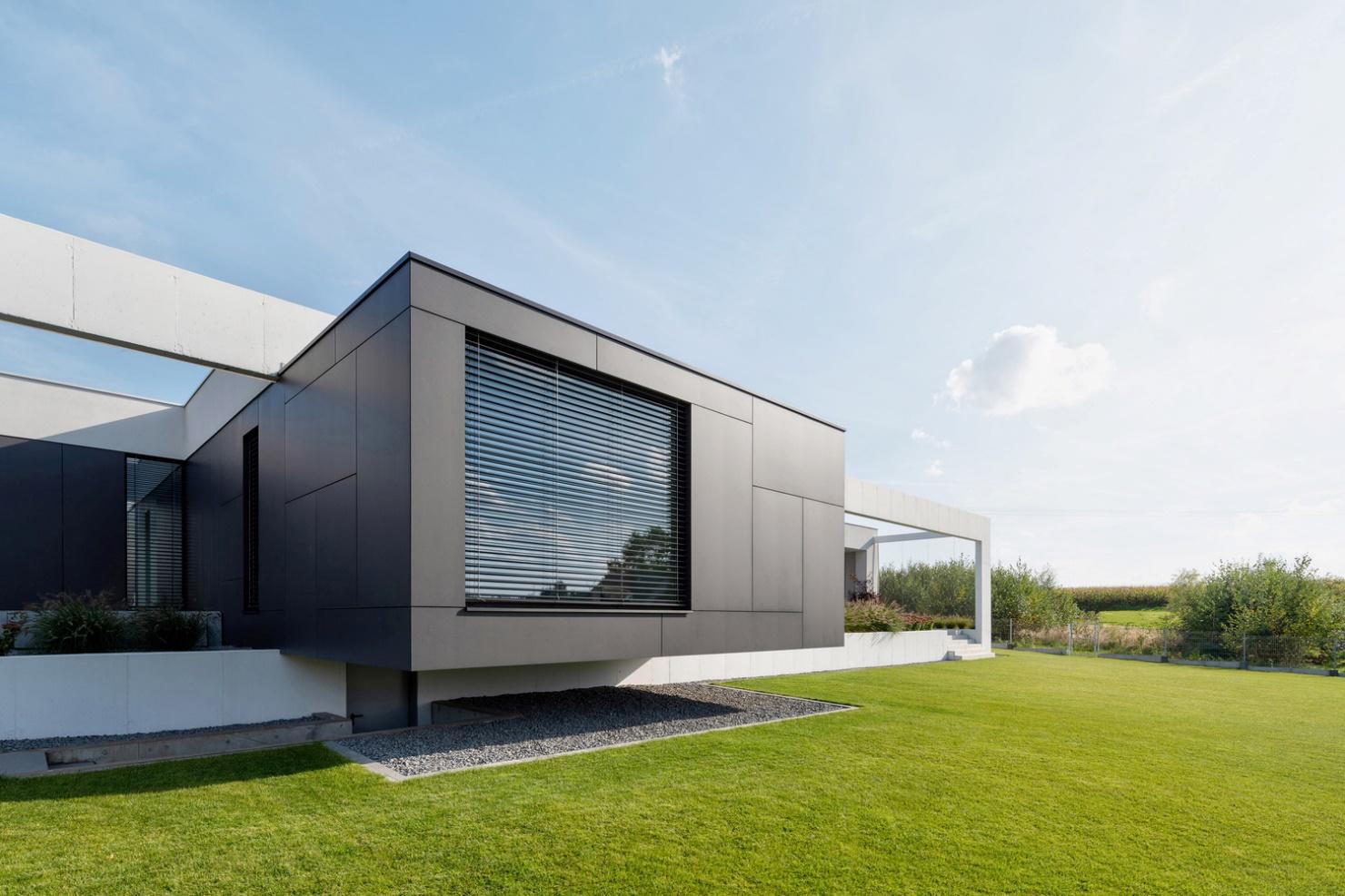 Minimalist concrete house design with a patio and large terraces