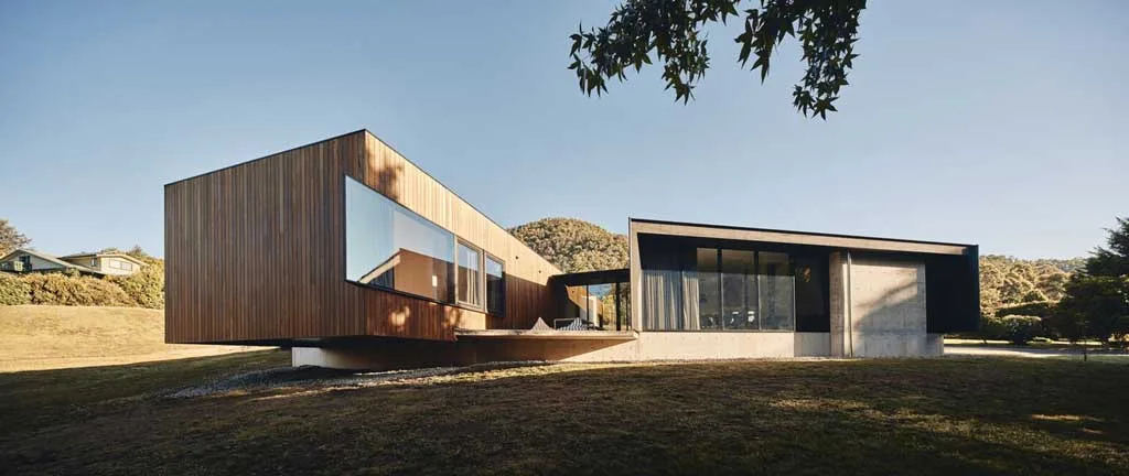 Landscape-Responsive Design with Blackbutt Cladding and Concrete Foundations in Alpine Shire