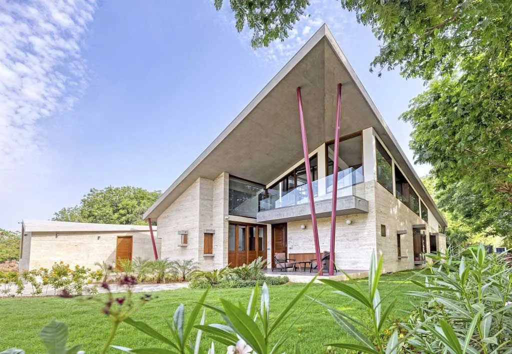 Travertine Stone Clad Residence with Diagonal Orientation and RCC Gable Roof