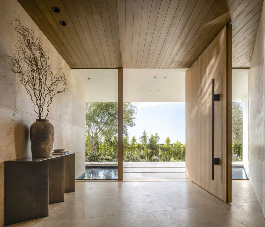 Fluid, Curved Forms with Stone, Timber, and Bronze Interiors