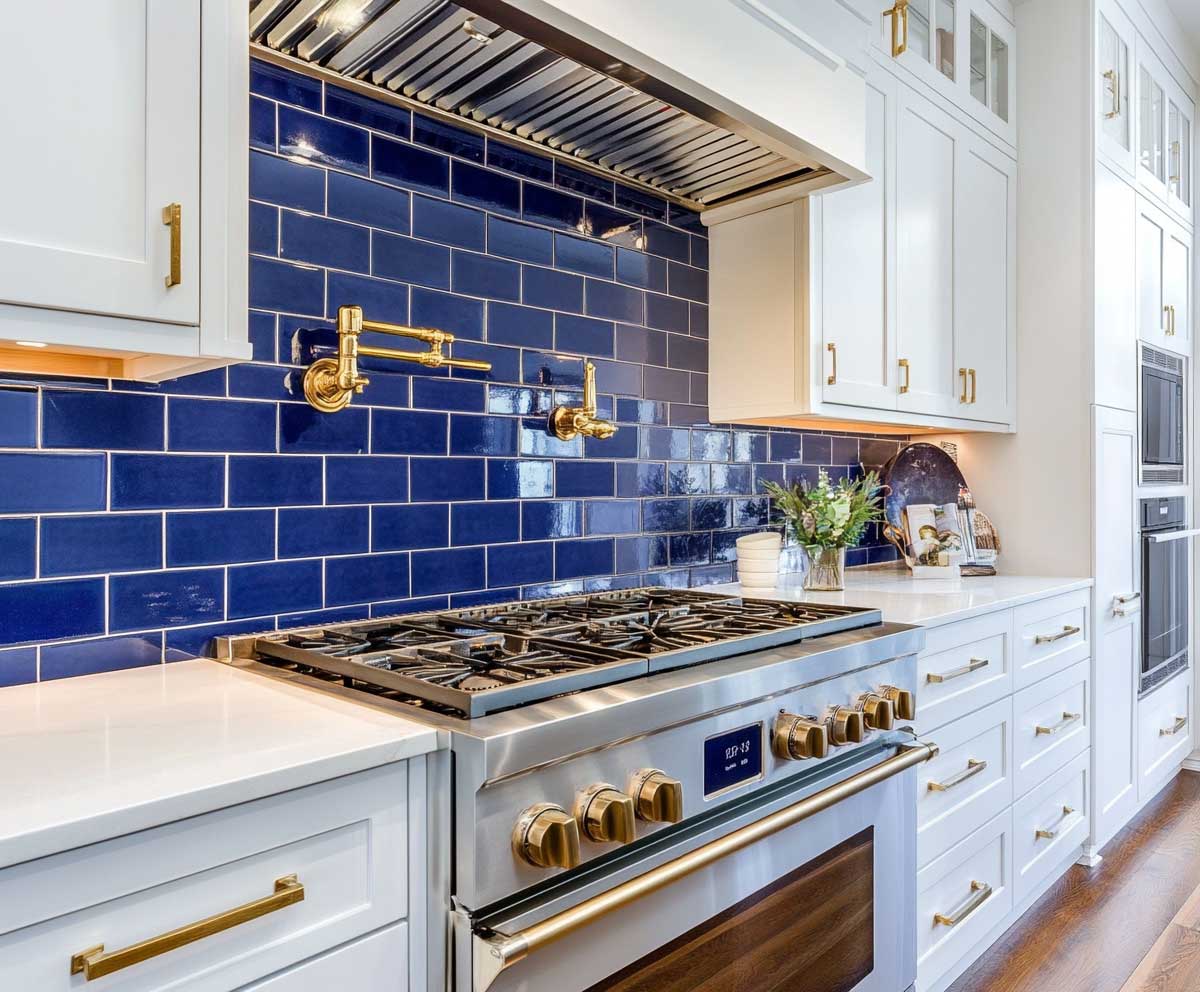 sleek navy blue subway tile backsplash with glossy finish, surrounded by bright white cabinets, gold hardware, well-lit kitchen interior, clean lines and stylish contrast