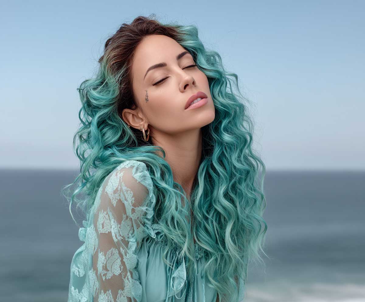 Model with aqua teal long curly hair, messy beachy spirals, ocean breeze effect, natural curl volume, serene sea background, wind in hair, full length, vibrant editorial fashion