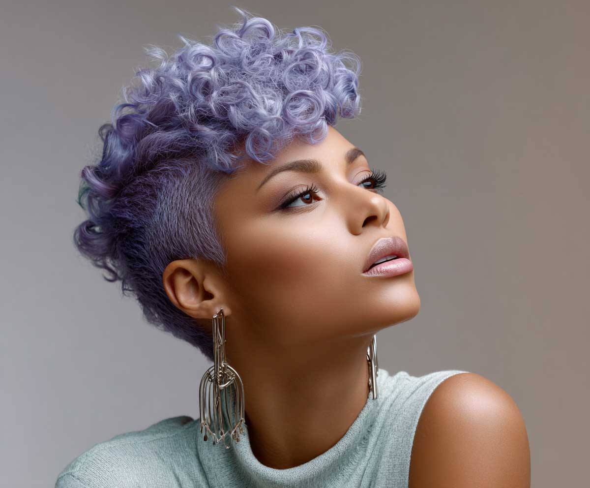 close-up fashion photo of a woman with a lavender violet curly pixie cut, defined side part, sculpted curls, soft background, dreamy lighting, studio setting with pastel styling