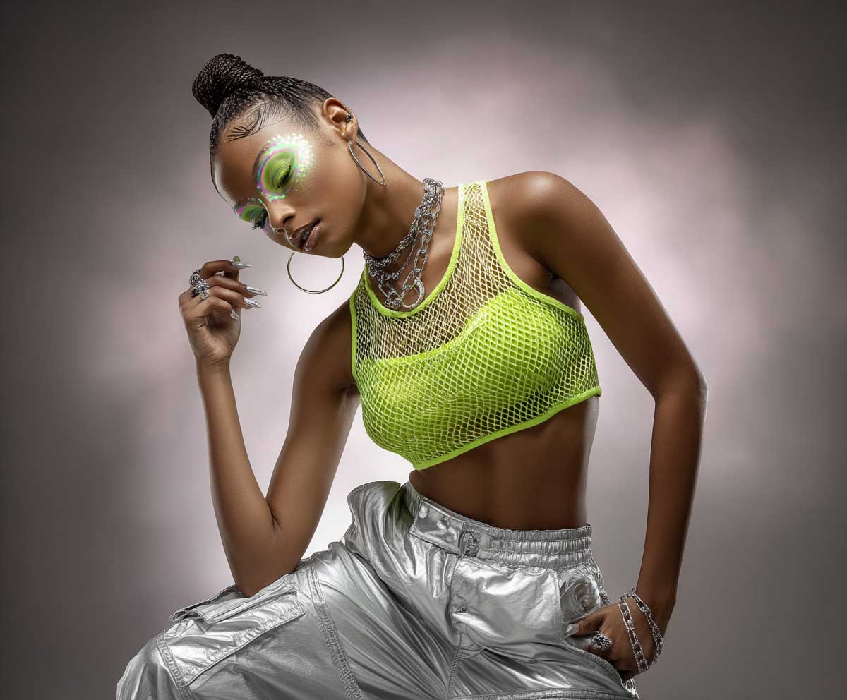 full-body photo of a model at a rave, wearing a lime green neon mesh crop top and high-waisted silver cargo pants, holographic accessories, futuristic LED makeup, glowing background, dynamic pose, studio lighting, fashion editorial style