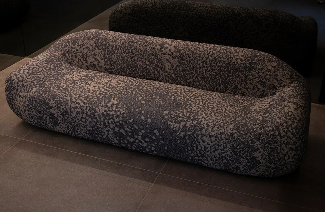 Curved beige sofa with rounded silhouette in contemporary living room interior