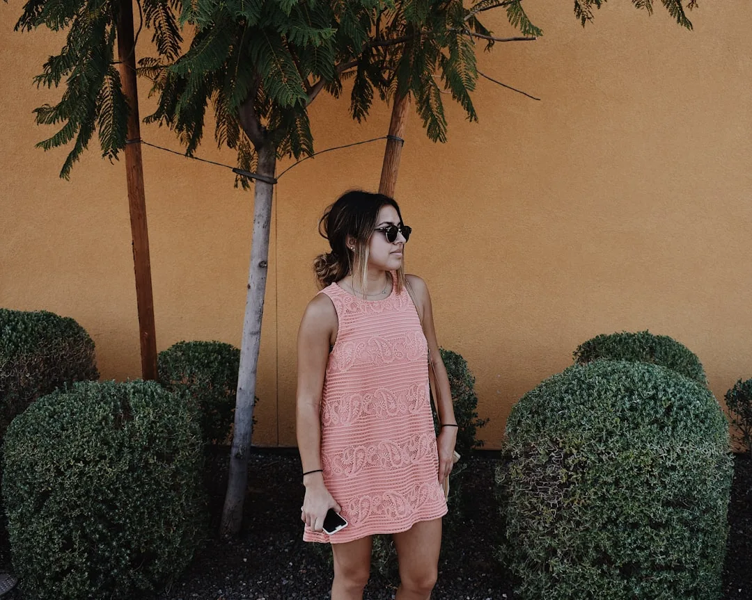 Cutout dress styling with minimal jewelry and neutral accessories