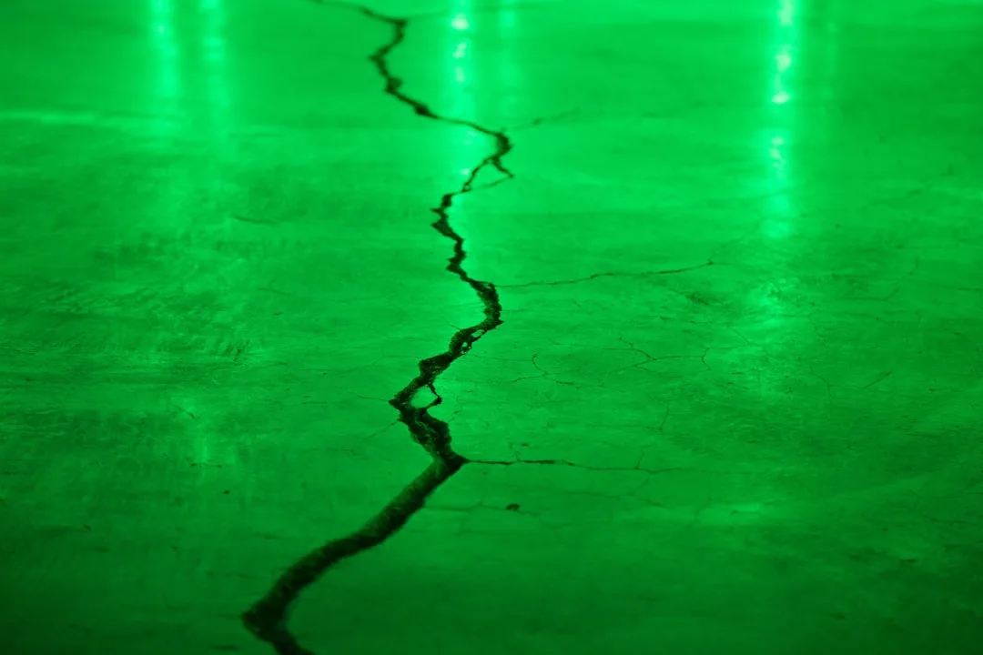 Self-healing concrete with microcapsules repairing cracks in modern facade detail 1