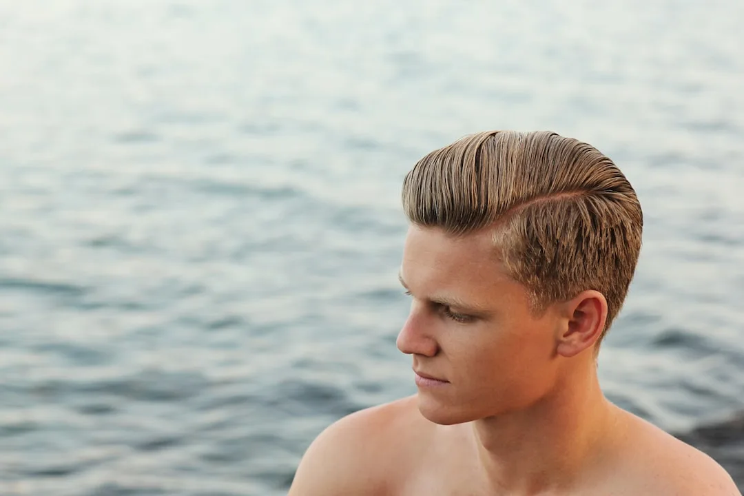 Modern men's slicked back hair with wet-look gel and pomade styling detail 1