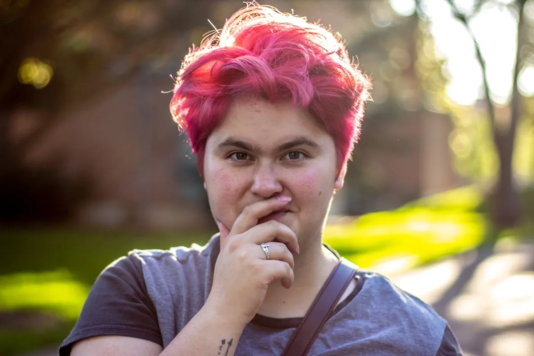 Woman with textured pixie hybrid cut showing side profile and tousled layers
