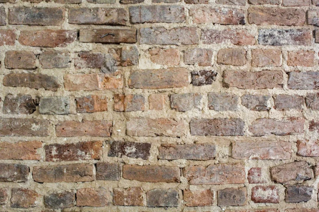 Reclaimed brick materiality with authentic patina texture detail on modern wall surface