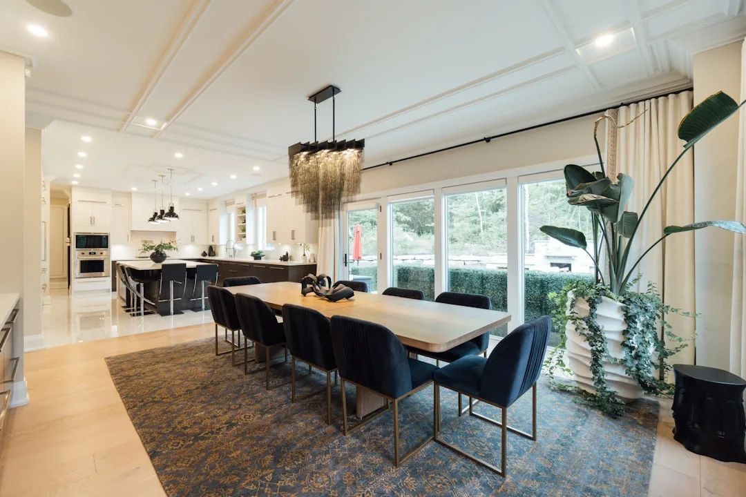 layered dining rugs under wooden table with natural fiber texture