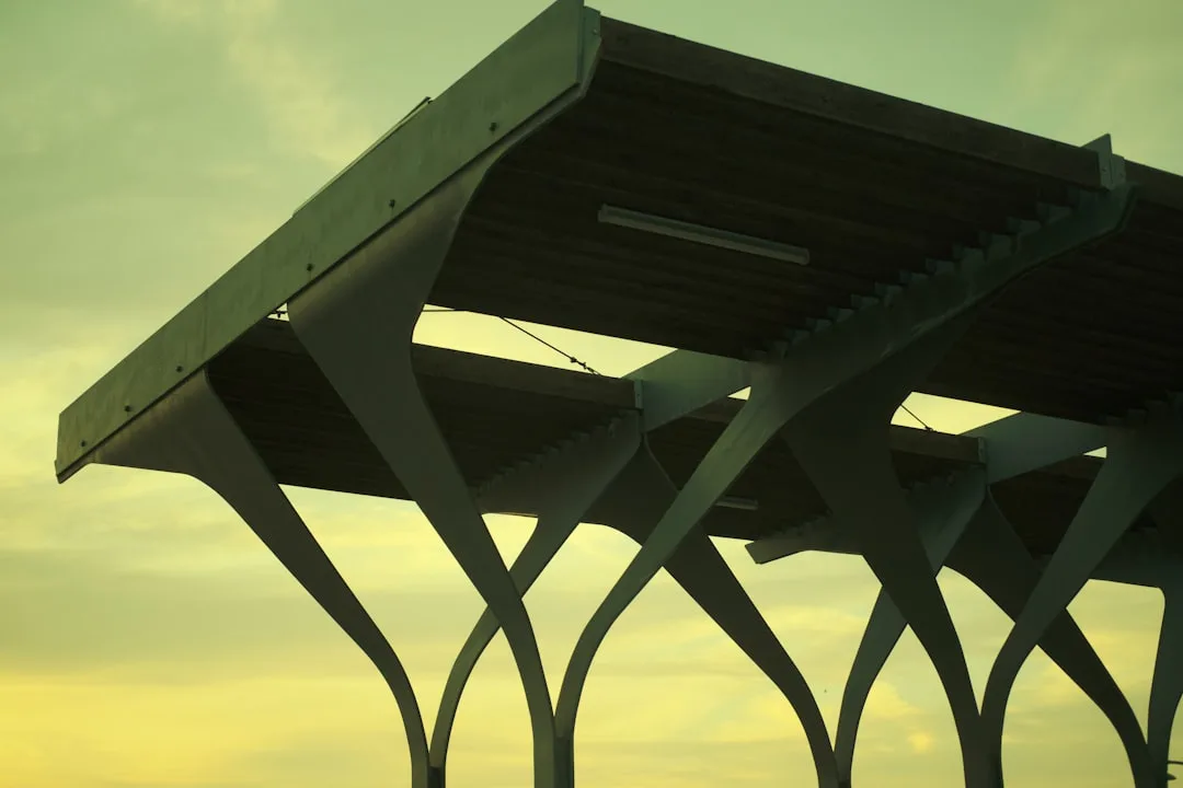 Contemporary motorized outdoor shade structure with retractable canopy covering patio detail 4