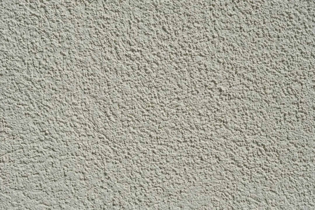 Natural plaster wall finish with warm earthy tone and organic texture detail detail 3