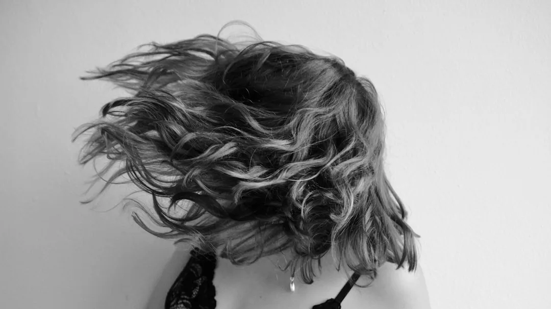 Side profile of textured layered haircut with piece-work styling