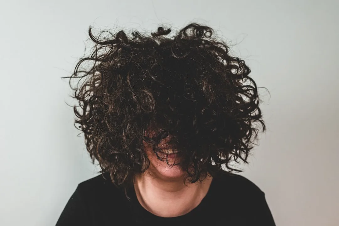 Textured layered haircut showing dimension and movement in mid-length hair detail 4