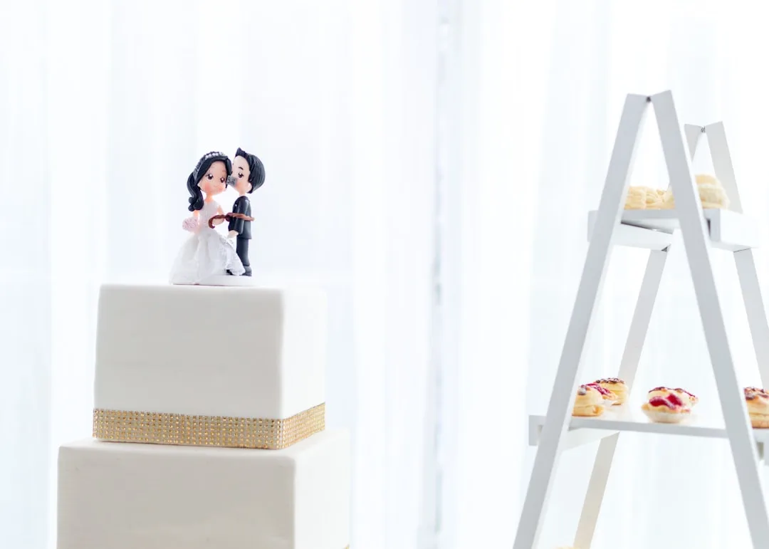 Sculptural wedding cake featuring stacked rectangular layers with minimalist piping