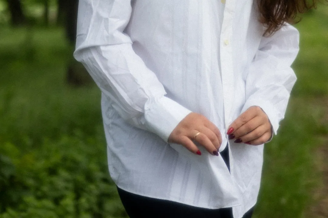 Oversized button-up shirt worn untucked over casual trousers with natural slouch silhouette detail 3