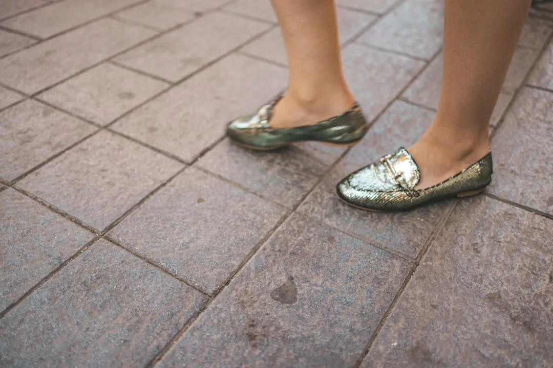 Metallic rose gold flats styled with cropped white linen trousers
