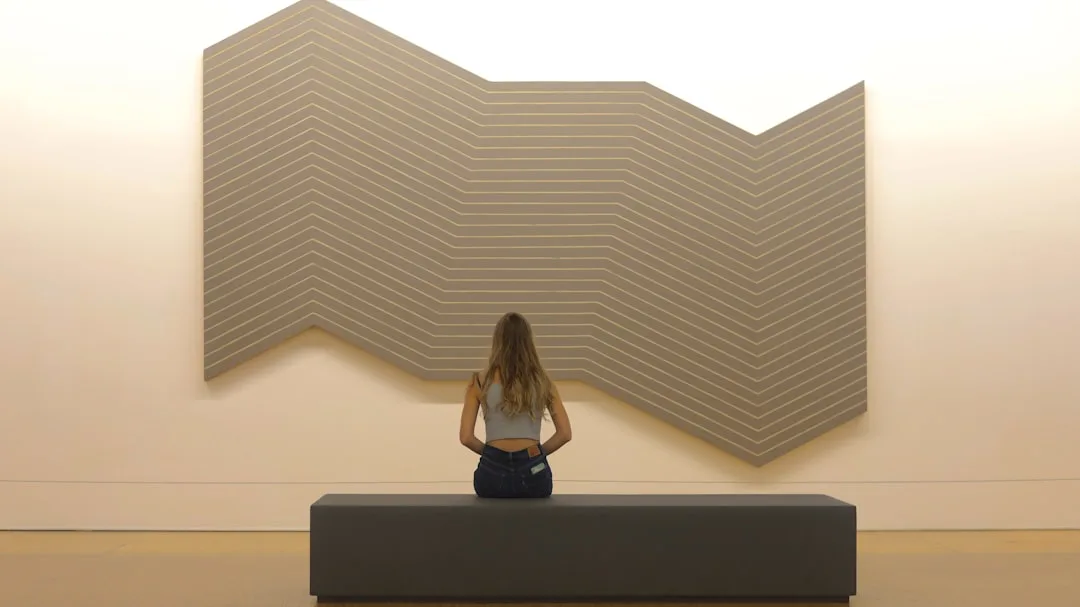 Natural wood acoustic slat panels installed floor-to-ceiling in home office space