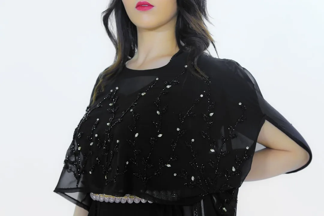 Woman wearing mesh overlay top over solid summer dress mesh fashion detail 4
