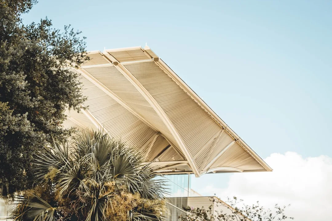 Motorized pergola with adjustable louver system controlling sunlight exposure