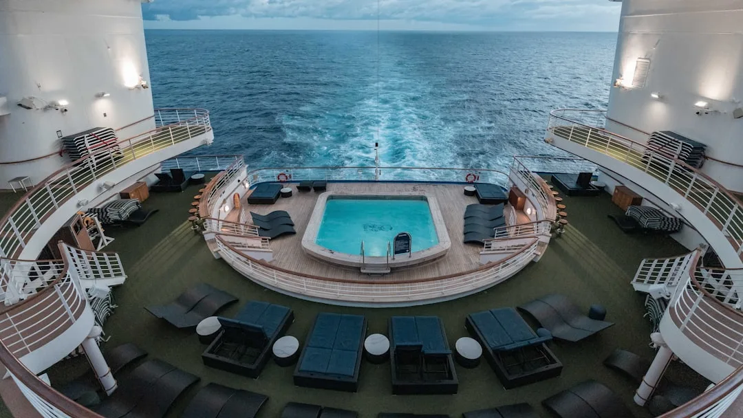 Luxury cruise ship amenities featuring infinity pool overlooking ocean waters