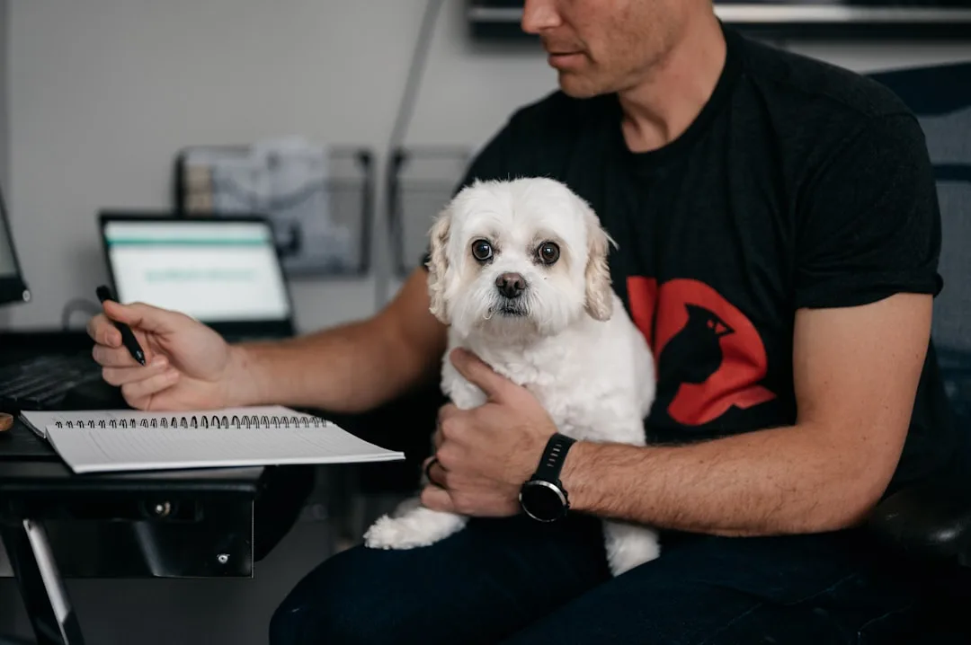 Pet owner video calling veterinarian on smartphone for pet telehealth consultation detail 1
