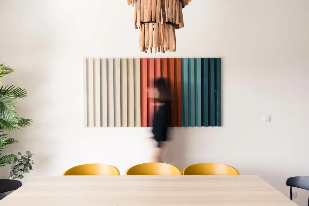 Charcoal acoustic foam panels arranged in geometric pattern on bedroom wall