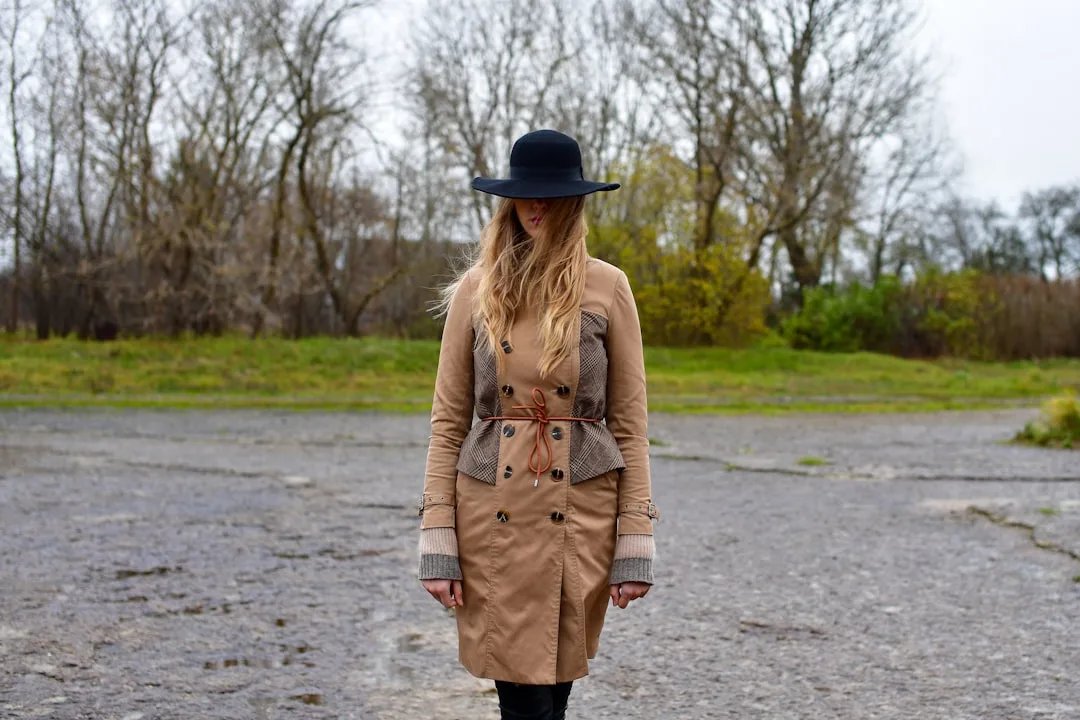 Neutral tones fashion outfit styled with taupe trench and cream knit