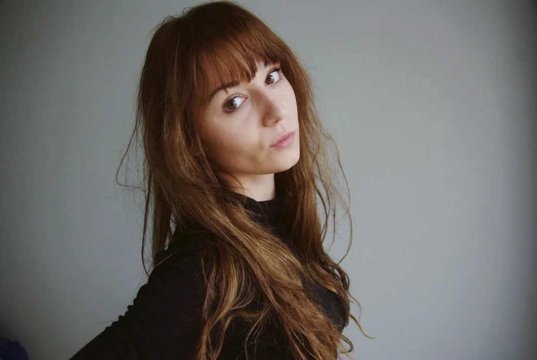 Textured curtain bangs styled with tousled waves and piece-work layers