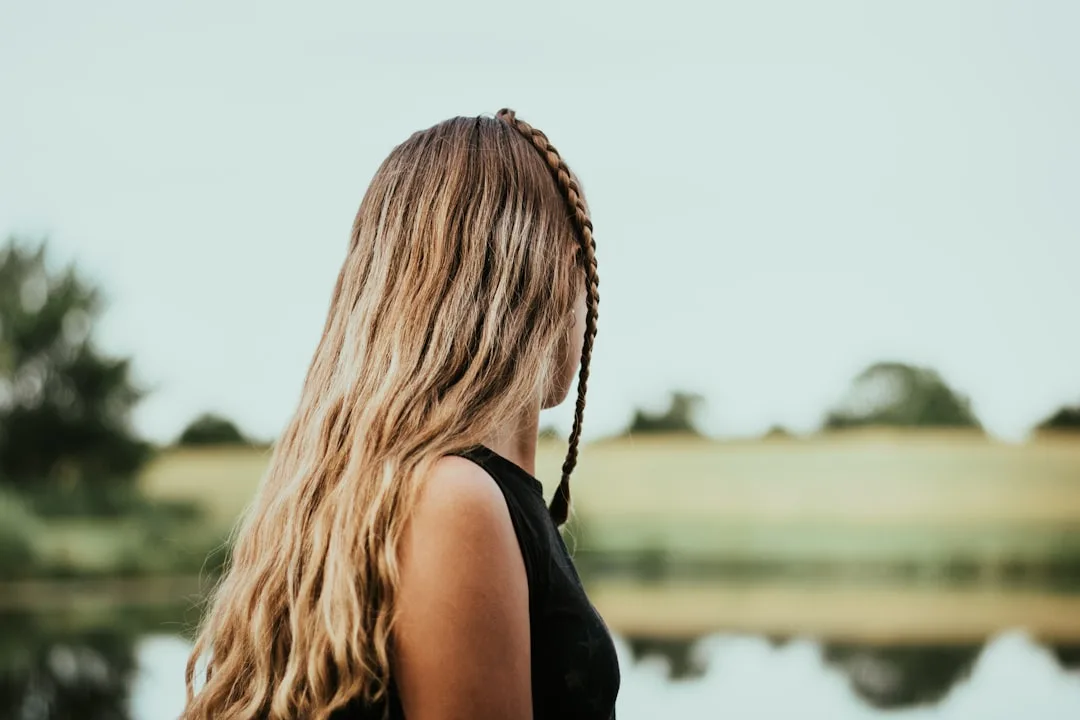 Side view of French braided hairstyle with glossy finish and clean edges