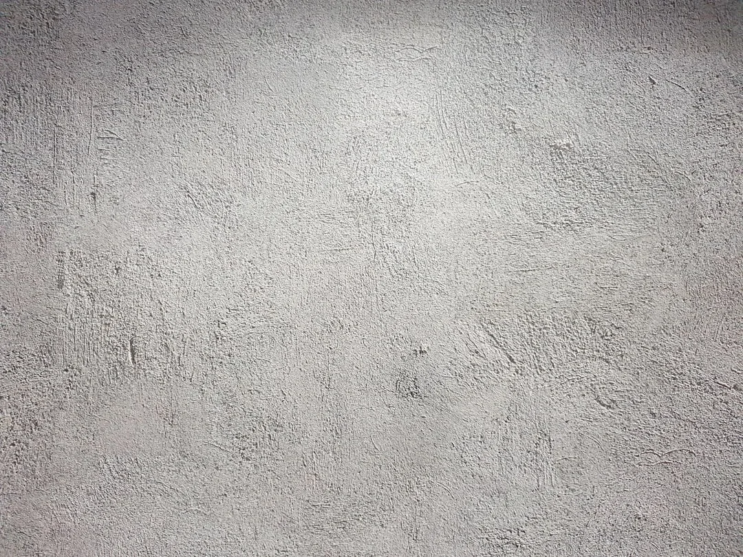 Natural plaster wall finish with warm earthy tone and organic texture detail detail 1
