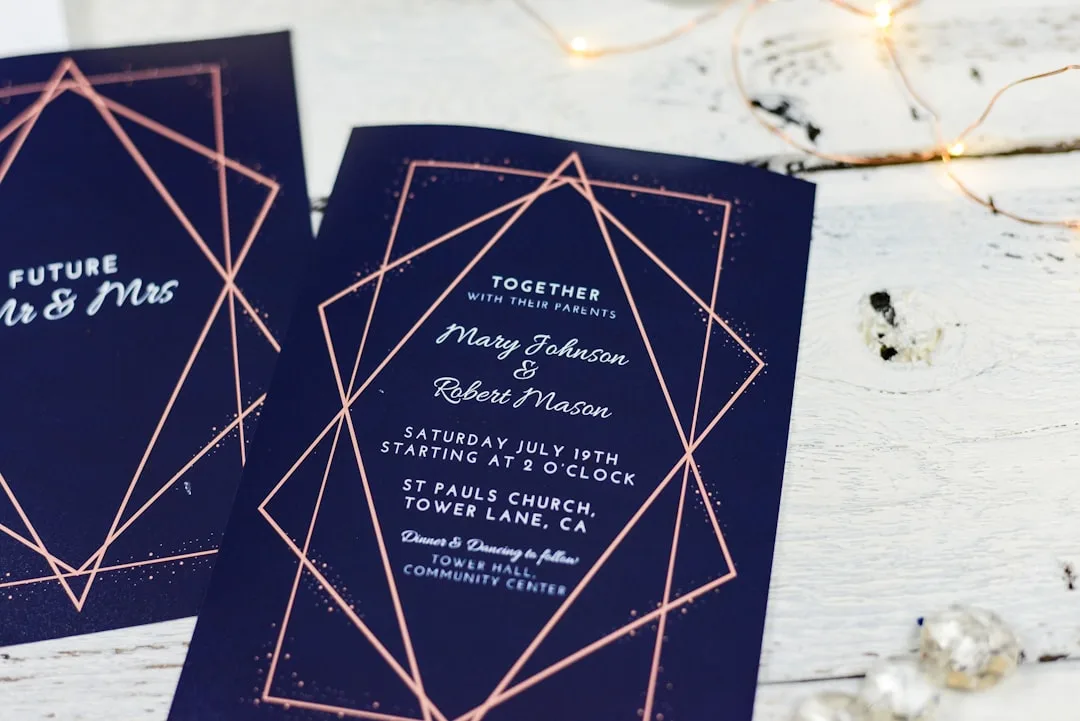 Close-up of textured wedding invitation with raised lettering and vellum overlay detail