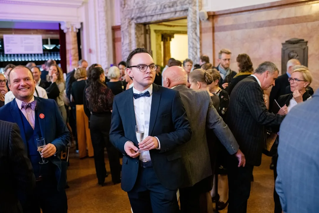 Modern cocktail reception event with standing guests mingling and networking detail 2