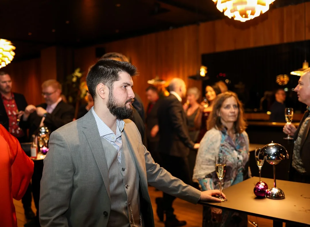 Modern cocktail reception event with standing guests mingling and networking detail 3