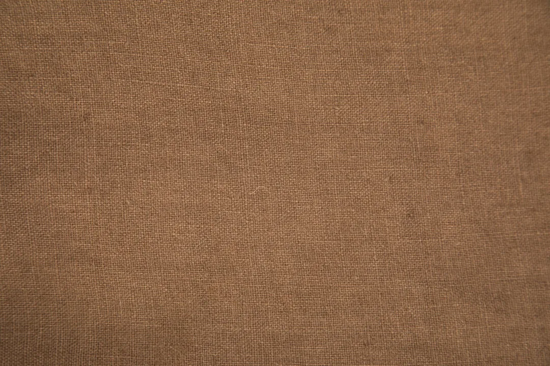 Close-up of japanese linen wall panel weave showing natural fiber depth