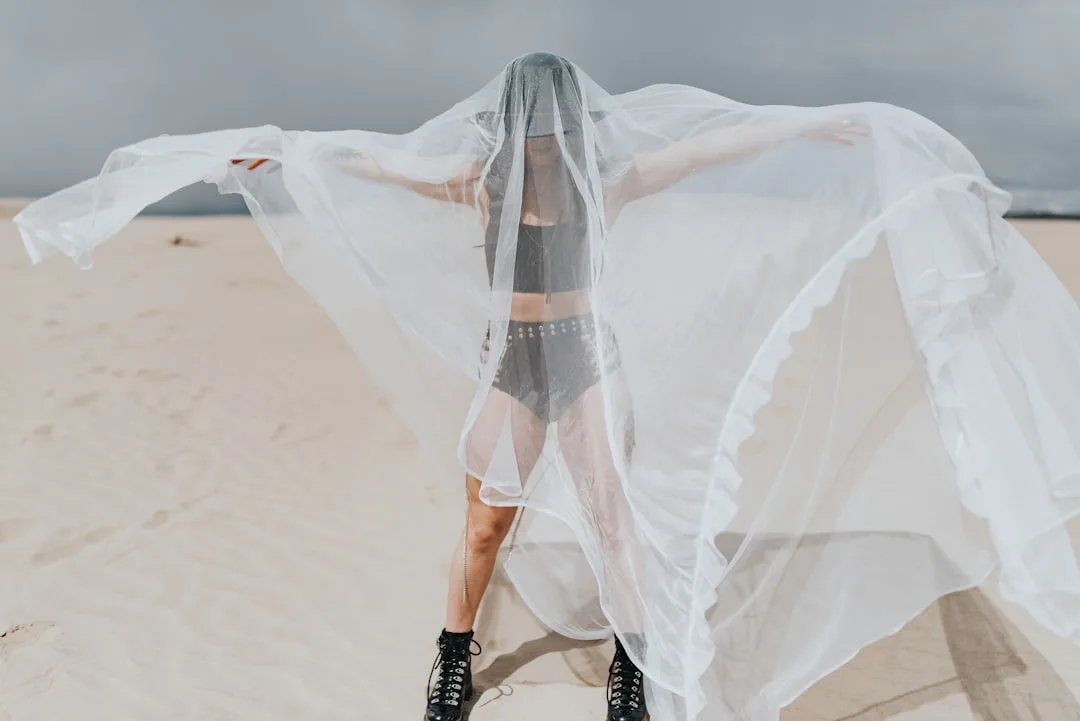 Woman wearing layered sheer fabrics in neutral tones for summer 2026 detail 4