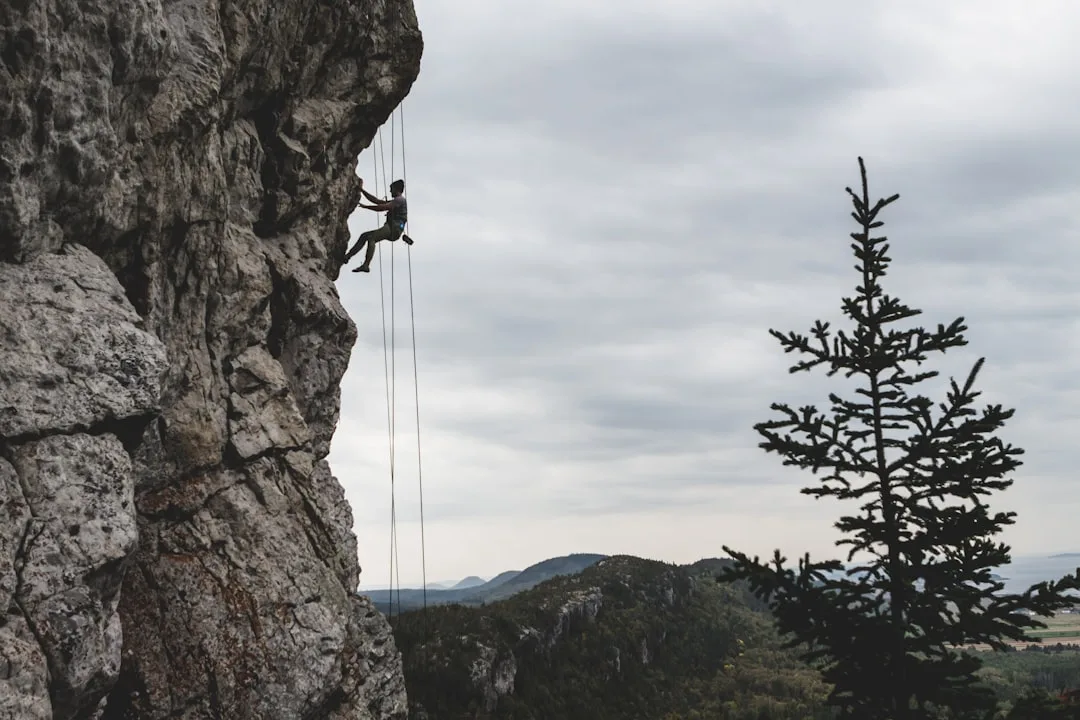 Hiker on alpine trail with emergency first aid kit visible
