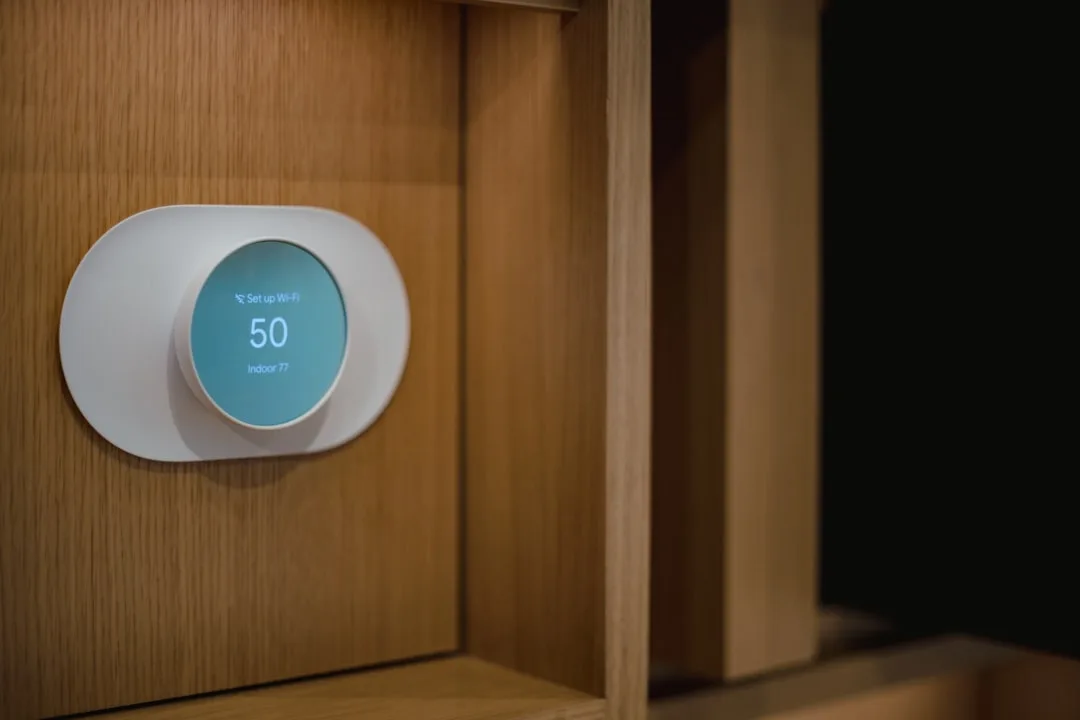 E Ink ambient display showing weather and calendar in neutral bedroom