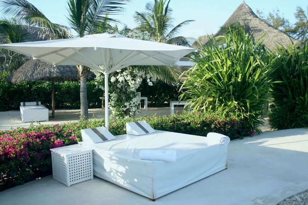 Weather-resistant daybed with integrated shade canopy in residential patio