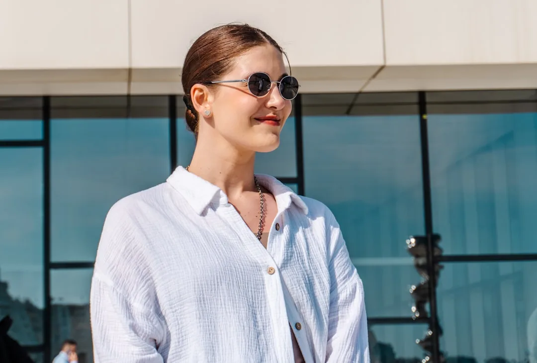 Oversized button-up shirt worn untucked over casual trousers with natural slouch silhouette detail 4