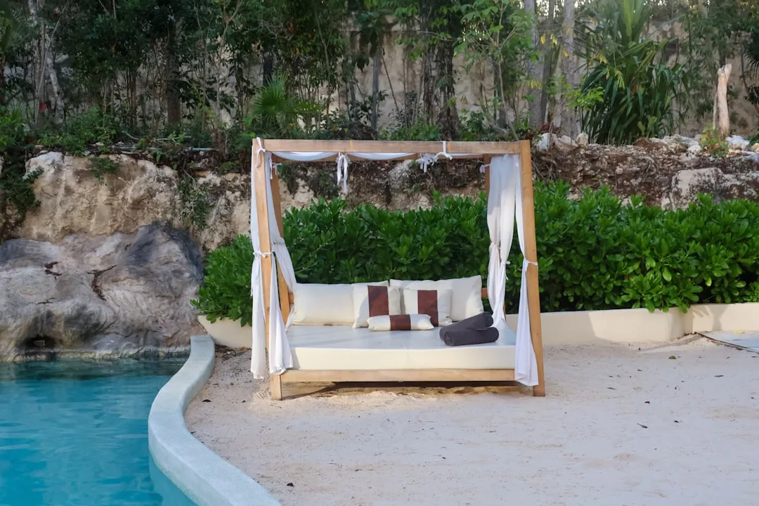 Luxury outdoor daybed lounge with canopy in contemporary backyard setting detail 4