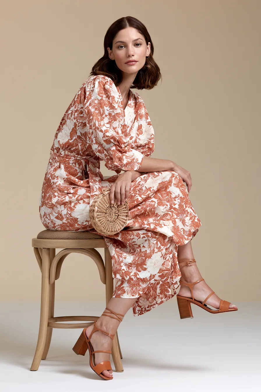 Woman in floral wrap midi dress — casual wedding guest outfit for women at a garden ceremony