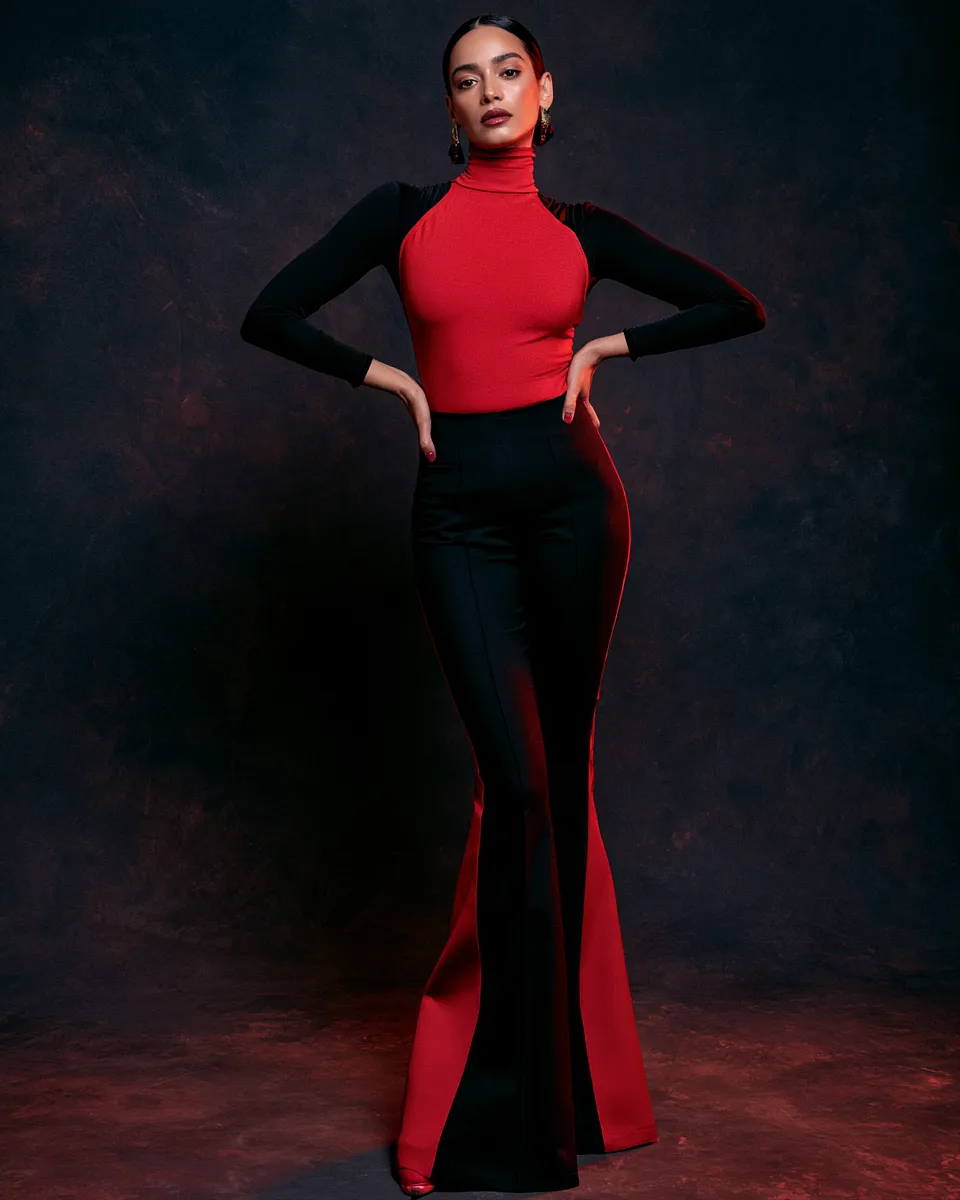 High-fashion editorial studio photography of a model in a stylish black and red outfit, confident full-body standing pose, dark atmospheric backdrop.