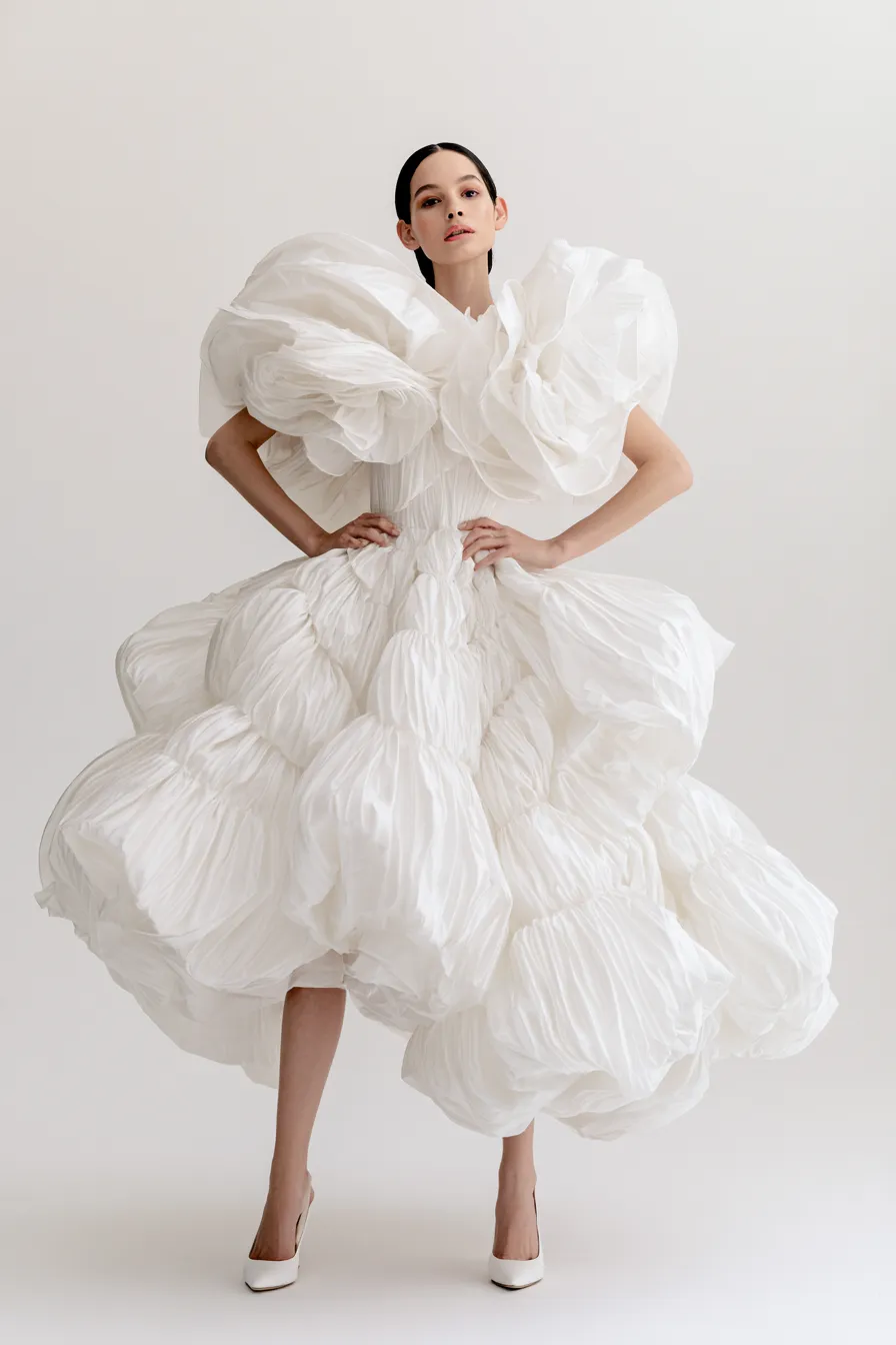 Full-length magazine shoot of a model in an elegant party outfit dress look