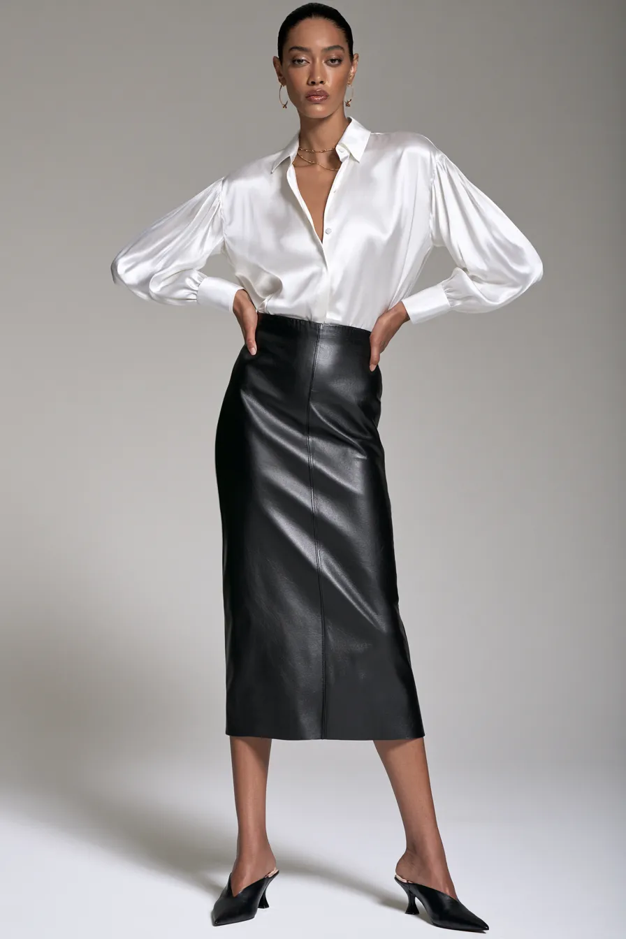 Black leather midi skirt with white silk blouse — minimalist leather skirt outfit idea