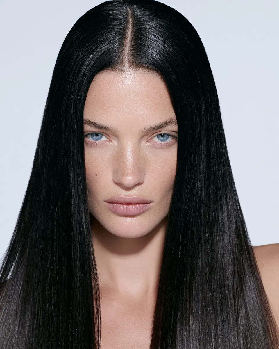 Fashion portrait of a model wearing a sleek straight hairstyle with mirror-like finish