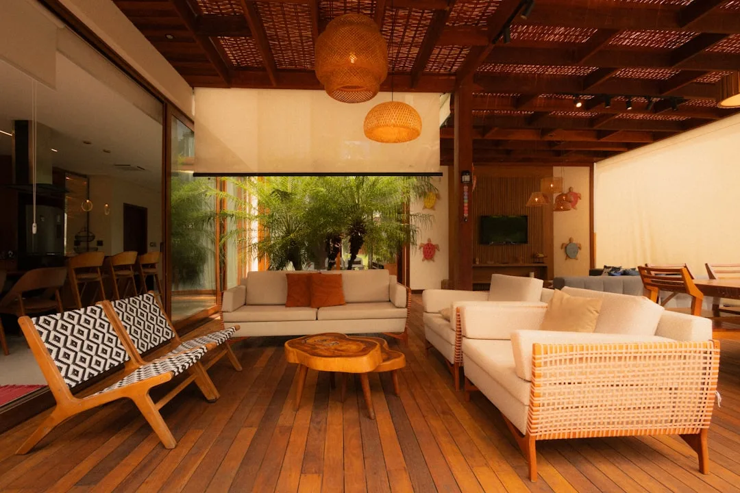 Covered outdoor living room extension with furniture and ambient lighting